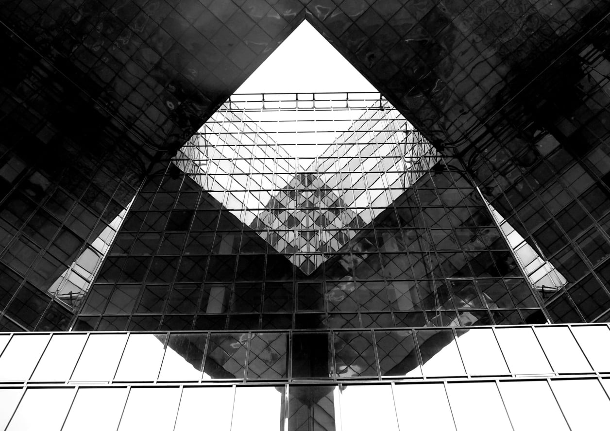 A view up the mirrored atrium of a building